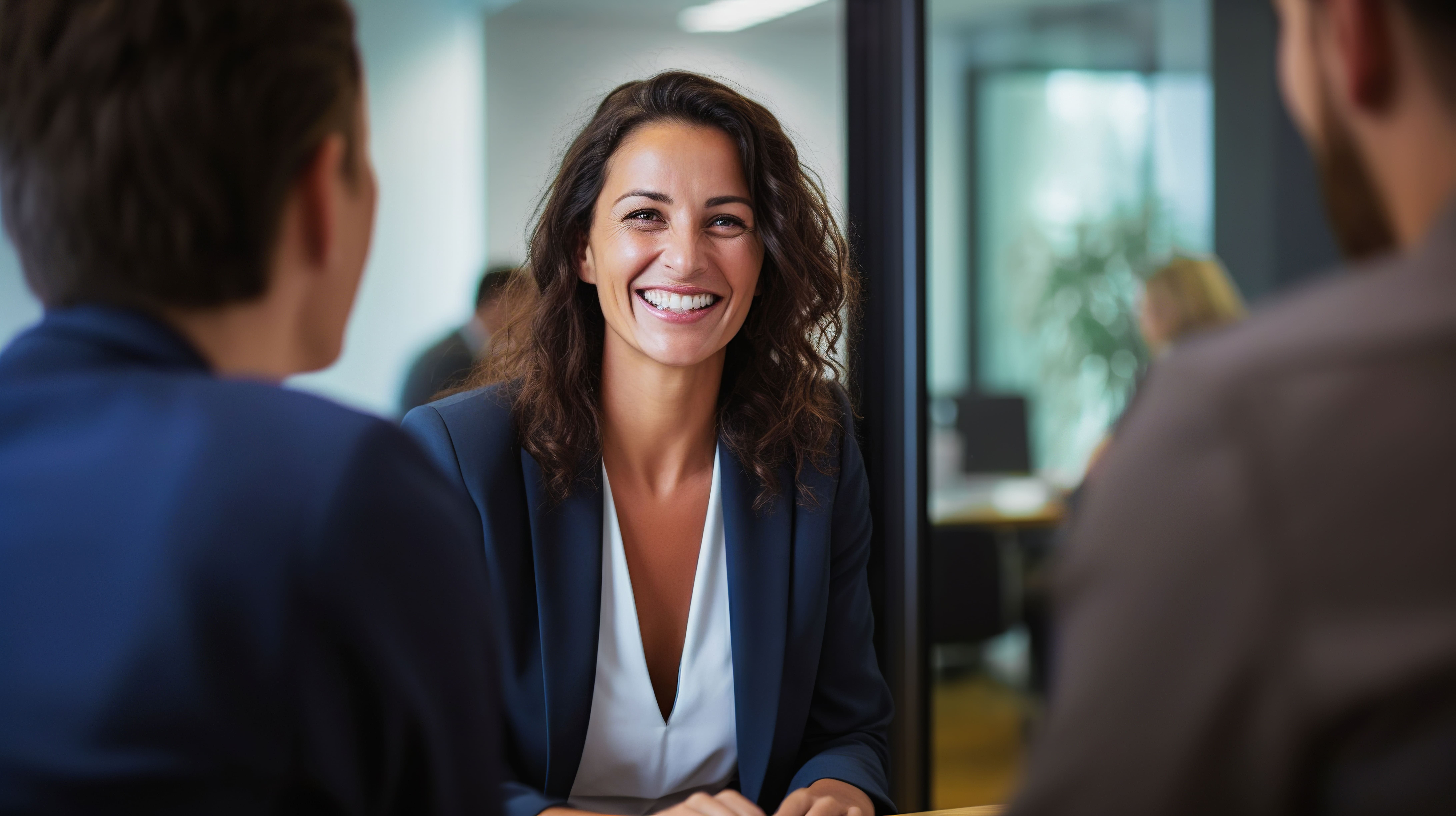 Handshake between smiling businesswoman and client at office meeting. Mid aged female manager or hr hiring new recruit, bank or insurance agent, or lawyer making contract deal at work